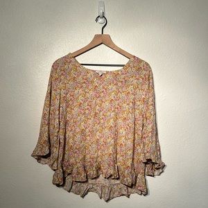 Light floral top ruffled, bottom, bell sleeves with ruffles.. Never worn